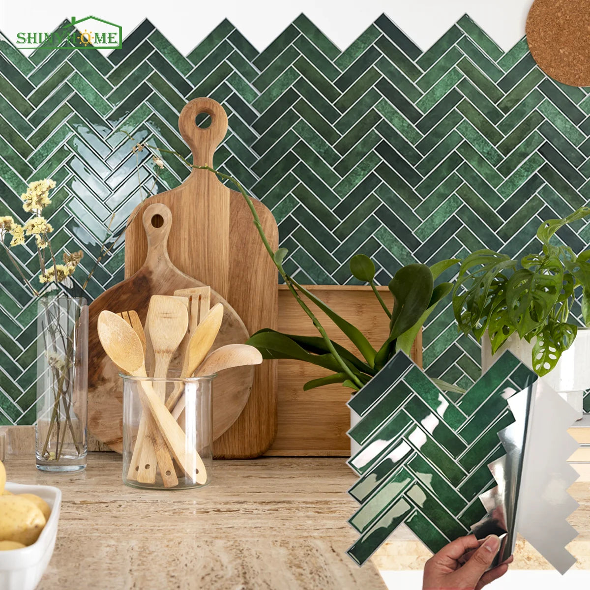Green herringbone tile backsplash with wooden utensils and cutting boards on counter.