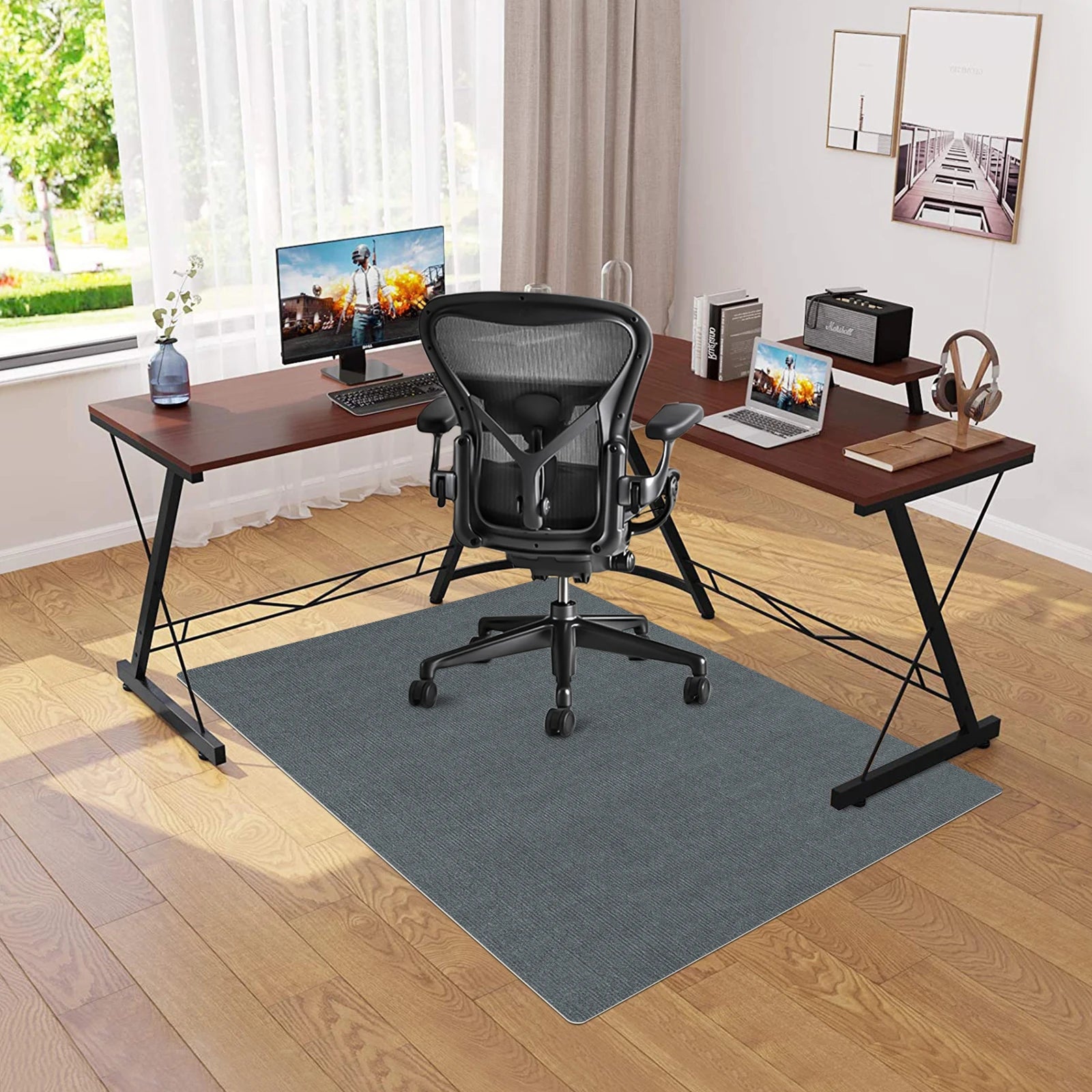 Modern home office with L-shaped desk, ergonomic chair, and dual monitors.