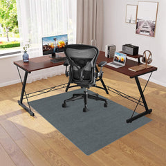 Modern home office with L-shaped desk, ergonomic chair, and dual monitors.
