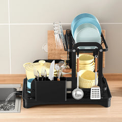 Black kitchen dish rack with plates, bowls, utensils, and hanging kitchen tools.
