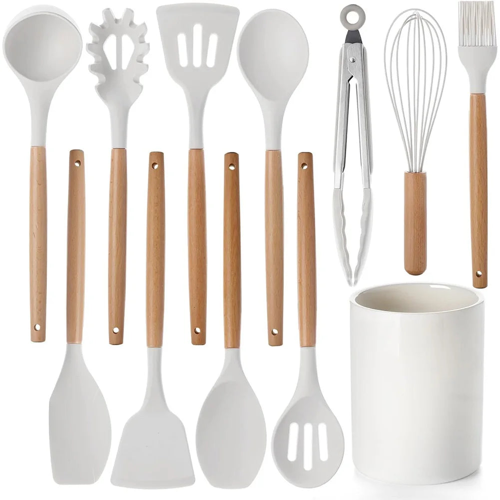 Wood handle kitchen utensils set with white heads and a white utensil holder.